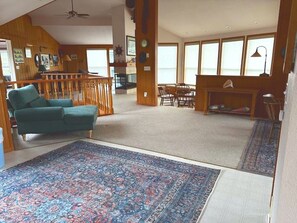 A spacious living area with a large rug, wooden furniture, and a view of the outdoors. - Captain's Lookout 3-bedroom house in Dillon Beach perfect for relaxing getaways (Dillon Beach)