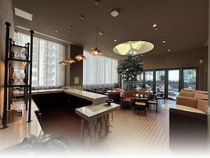 A modern interior with a kitchen island, seating area, and large windows.