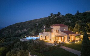 A stone house with a red roof, a swimming pool, and a mountainous backdrop. - VILLA ONIRO, Your Villa (Chania)