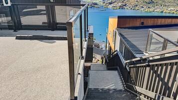A staircase leading to a building with a view of a lake and mountains.