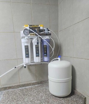 A water filtration system with multiple bottles and a water jug.