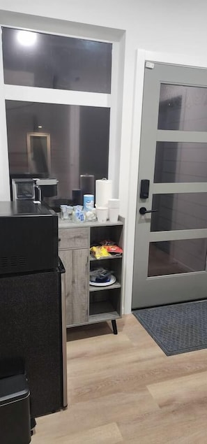 A compact kitchen with a microwave, coffee maker, and storage cabinets. - Modern Spacious 1-BR Automated Haven: Work-Ready - Private Room in Townhome (Seattle)