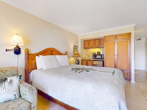 A hotel room with a bed, a sofa, a desk, and a kitchenette. - Islander on the Beach | Oceanview, A/C, Pool (Kapaʻa)