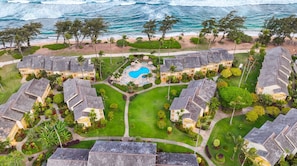 A resort with multiple buildings, a central pool, and a beach view. - Islander on the Beach | Oceanview, A/C, Pool (Kapaʻa)