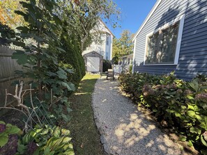 A residential property with a gravel pathway, a wooden fence, and a shed. - Coastal Marblehead Retreat, Minutes to Salem, Beautifully Renovated (Marblehead)