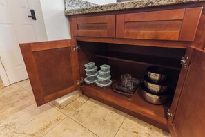 A kitchen with a wooden cabinet, a granite countertop, and a tiled floor. - Private pool paradise w/ping pong, foosball & outdoor fire pit! (Tempe)