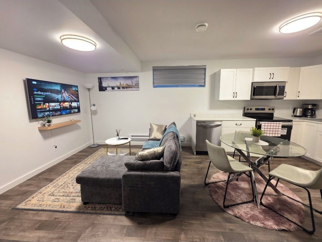 A modern kitchen with white cabinets, a microwave, and a coffee maker.