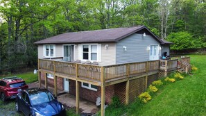 A two-story house with a deck, a garage, and a driveway. - Lovely 5-bedroom / 2 Bathroom / Pet-friendly (McHenry)