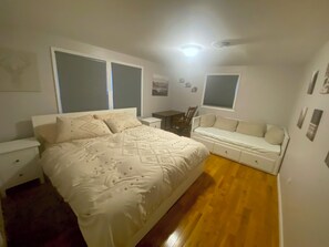 A bedroom with a bed, bedside tables, a chair, a desk, and a window. - Lovely 5-bedroom / 2 Bathroom / Pet-friendly (McHenry)