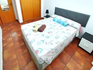 A bedroom with a bed, a nightstand, a drawer, and a door. - MAREVERDE WIFI FREE & POOL VIEW (Costa Adeje)