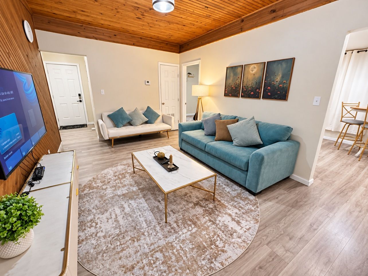 A living room with a sofa, coffee table, and television.