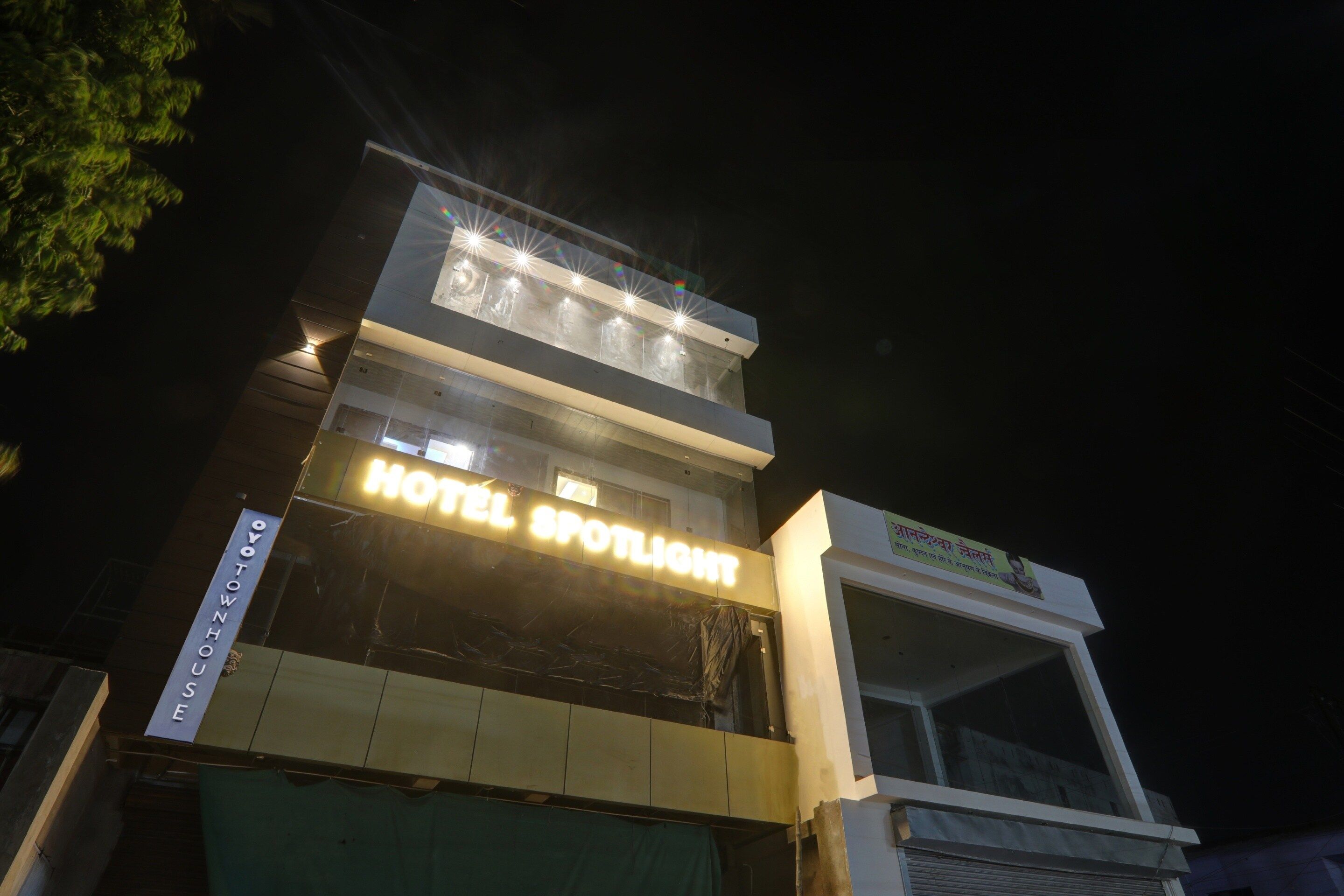A hotel with a prominent sign reading 'HOTEL SPOTLIGHT' and a visible entrance.