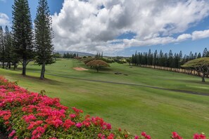 A golf course with a clear sky, green grass, and trees. - New Listing: #11P8 Luxury Ocean-View Condo in Kapalua Maui | 2BR Golf Villas Retreat (Lahaina)
