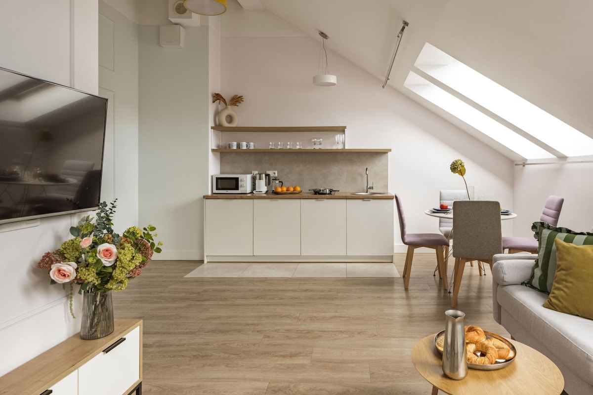 A modern apartment with a kitchen, dining area, and living space.