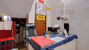 A small office with a desk, chair, and a sign indicating a spot for CCTV cameras.