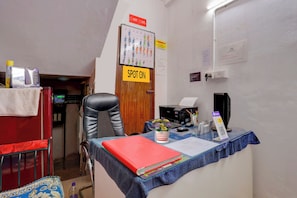A small office with a desk, chair, and a sign indicating a spot for CCTV cameras. - THE NEW VIEW HOTEL INN (Thiruvananthapuram)