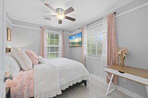 A bedroom with a bed, a desk, and a ceiling fan. - Golden Oaks Estate: Lagoon Pool, Treehouse, Private Lake & Acres of Waterfront Nature (Naples)