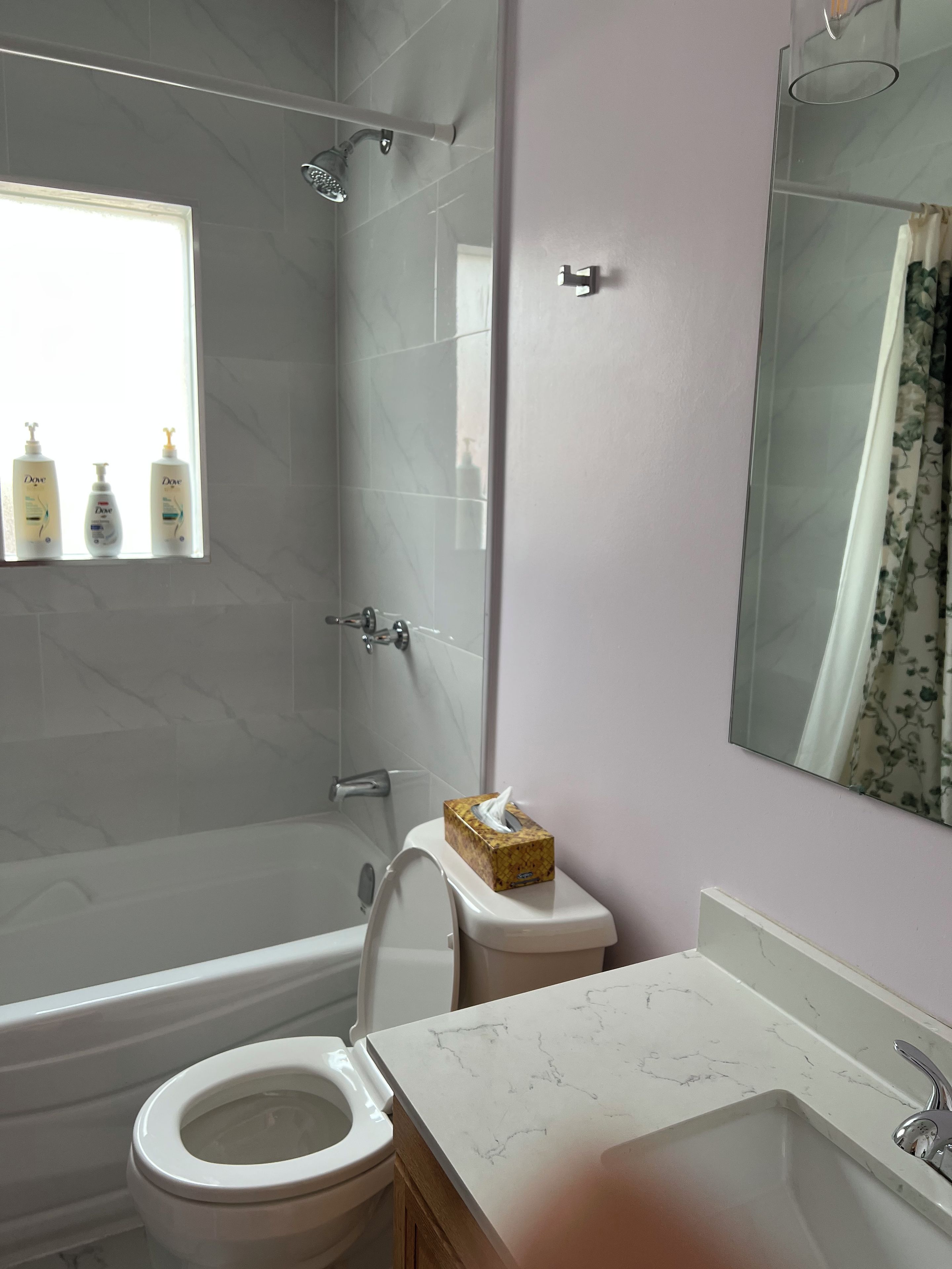 A bathroom with a shower, toilet, and sink.