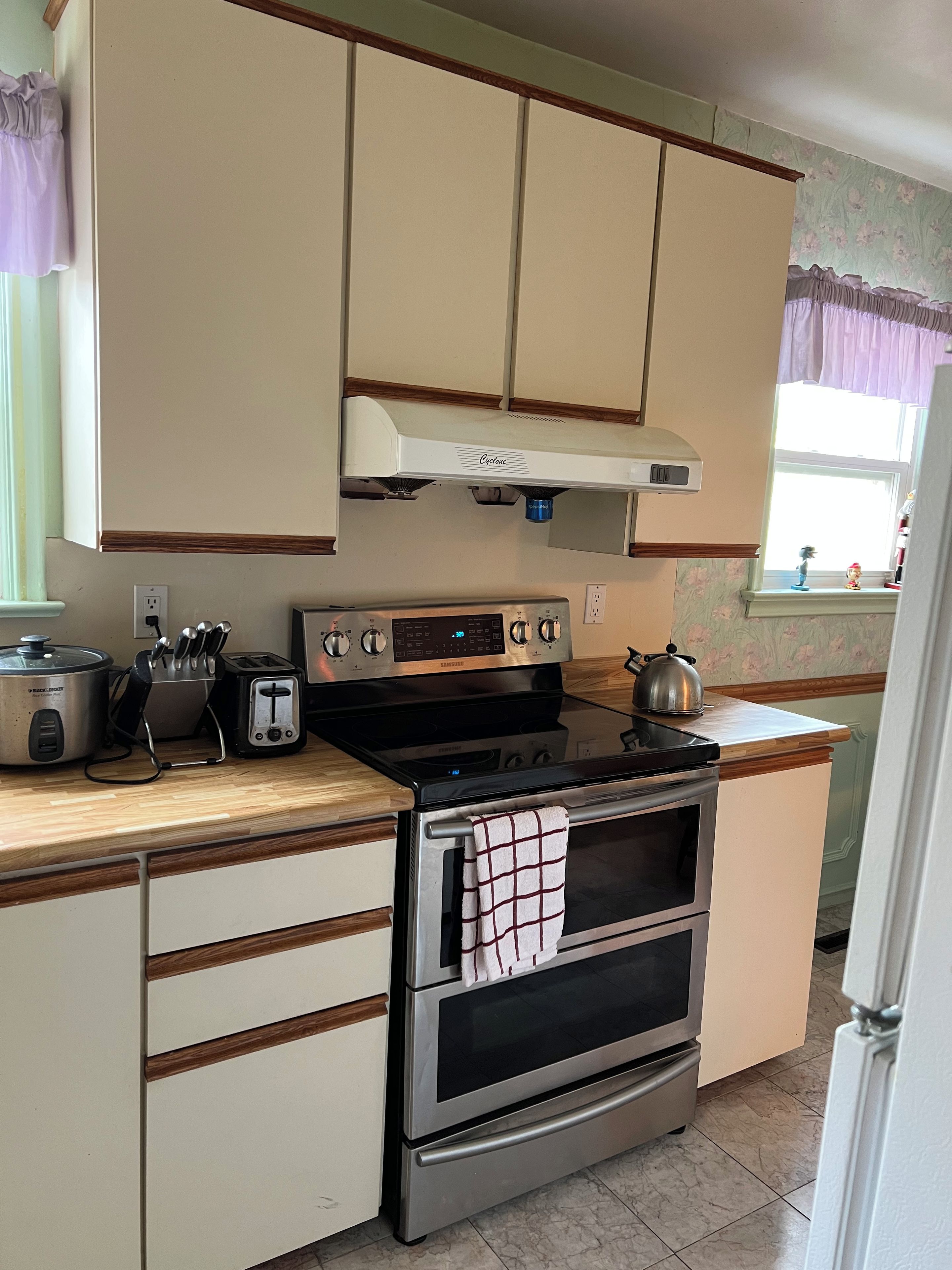 A kitchen with a stove, oven, and a toaster.