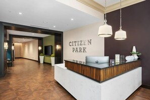 A reception desk with a sign reading 'CITIZEN PARK' and a laptop on it. - Landing | Chic 2BD in Central West End (St. Louis)
