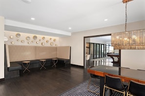 A modern conference room with a long table, black chairs, and a patterned wall. - Landing | Incredible 2BD in Central West End (St. Louis)