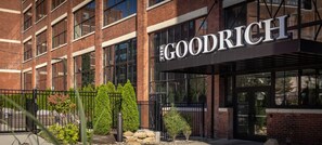 A building with a sign reading 'THE GOODRICH' and a brick facade. - Landing | Spectacular 2BD, Yoga Studio (Akron)