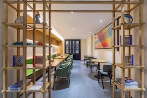 A modern interior with wooden shelving, seating, and a colorful abstract painting. - Jing'an TRUE GO Hotel  (Shanghai)