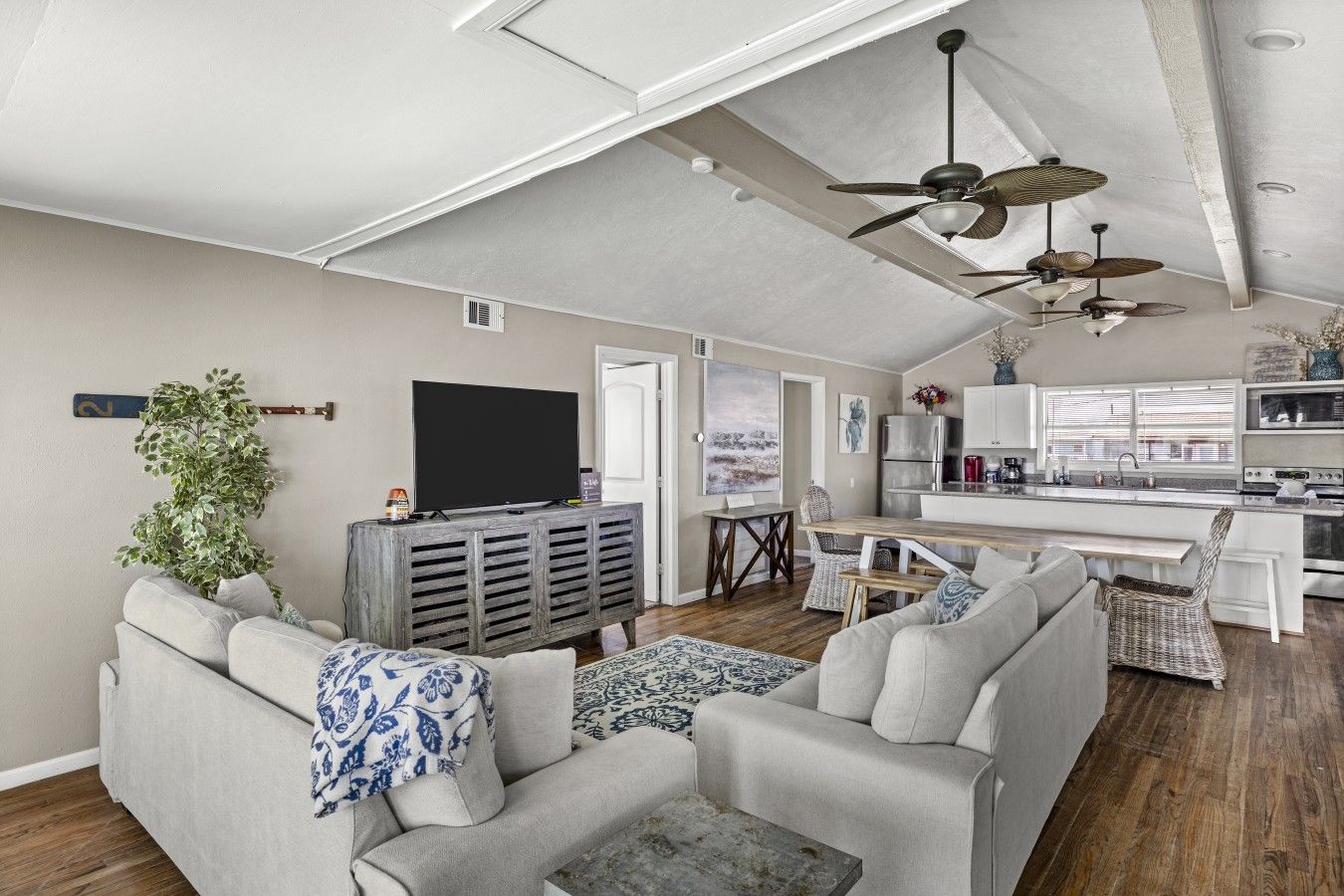 A modern living room with a sofa, a coffee table, and a television.