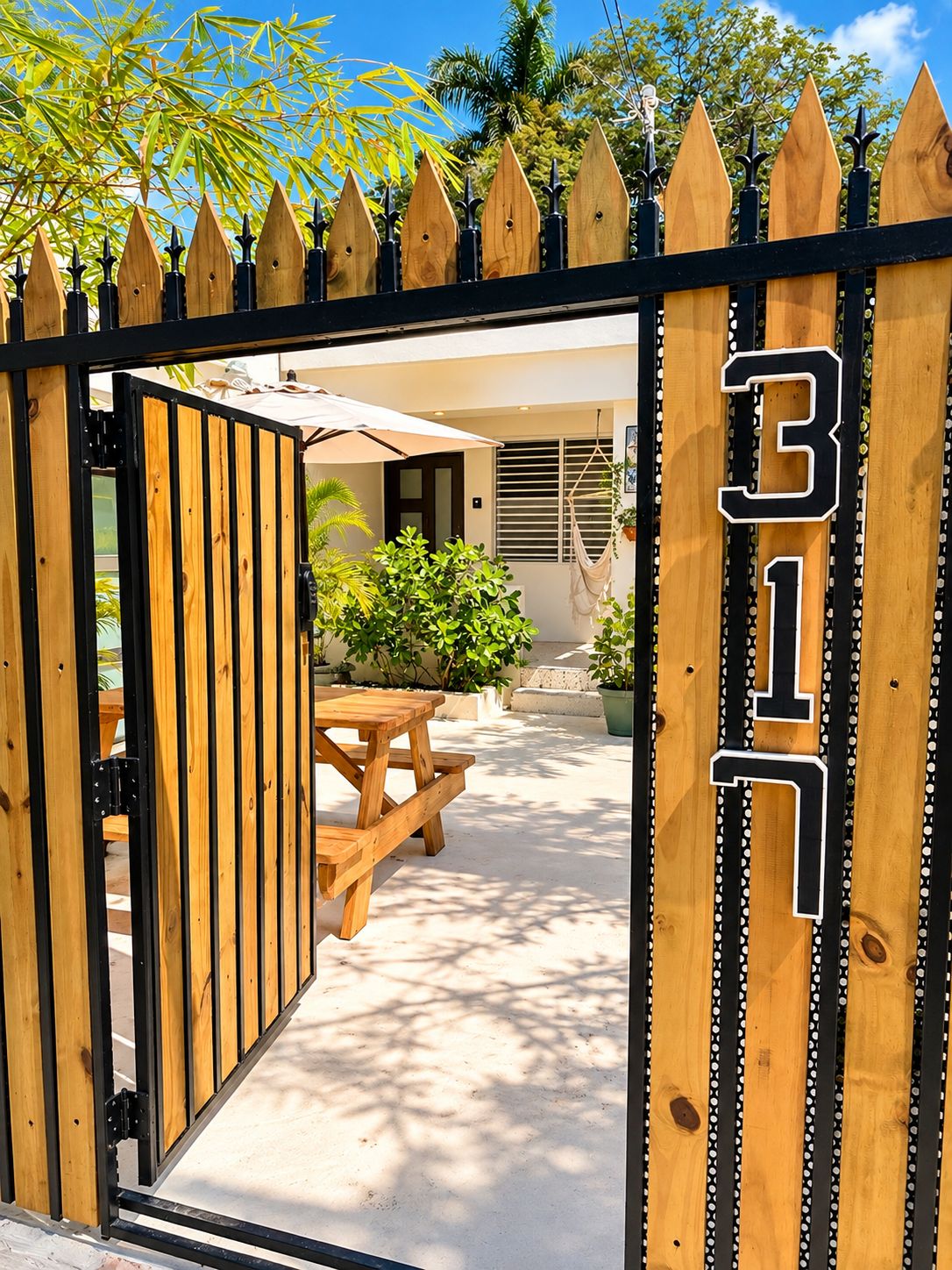 A gated entrance with a wooden fence and a number '317' sign.
