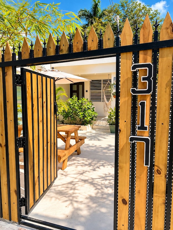 A gated entrance with a wooden fence and a number '317' sign.