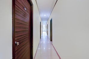 A corridor with a door marked '105' and a tiled floor.