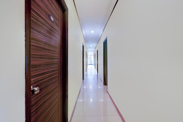 A corridor with a door marked '105' and a tiled floor.