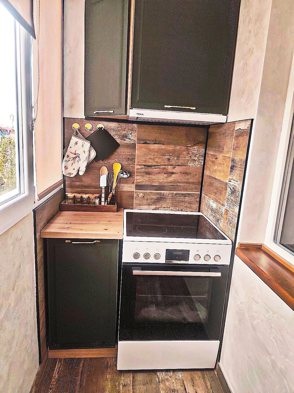 A compact kitchen with a stove, oven, and a small countertop.