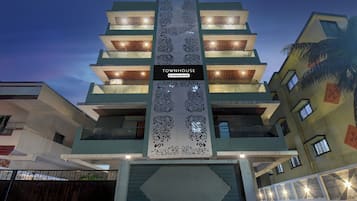 A multi-story building with a central vertical sign reading 'TOWNHOUSE' and 'Company House.'