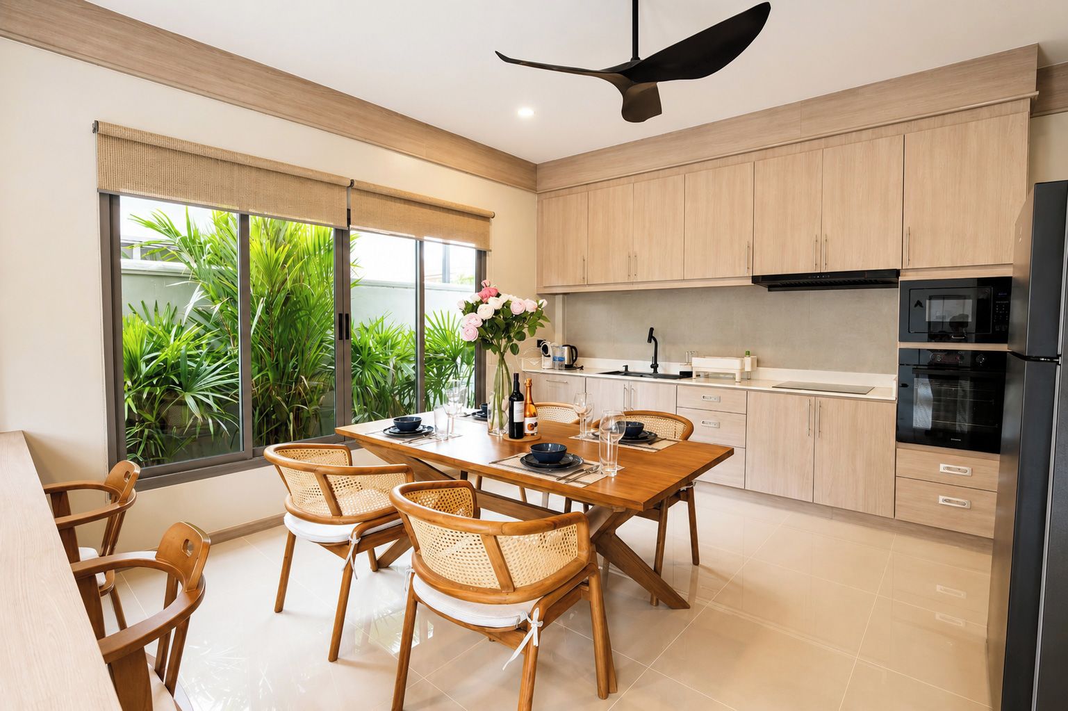 A modern kitchen with wooden cabinets, a dining table with chairs, and a ceiling fan.