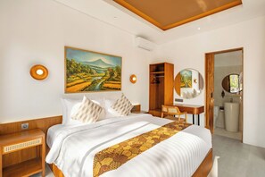 A hotel room with a bed, a desk, a wardrobe, and a bathroom.