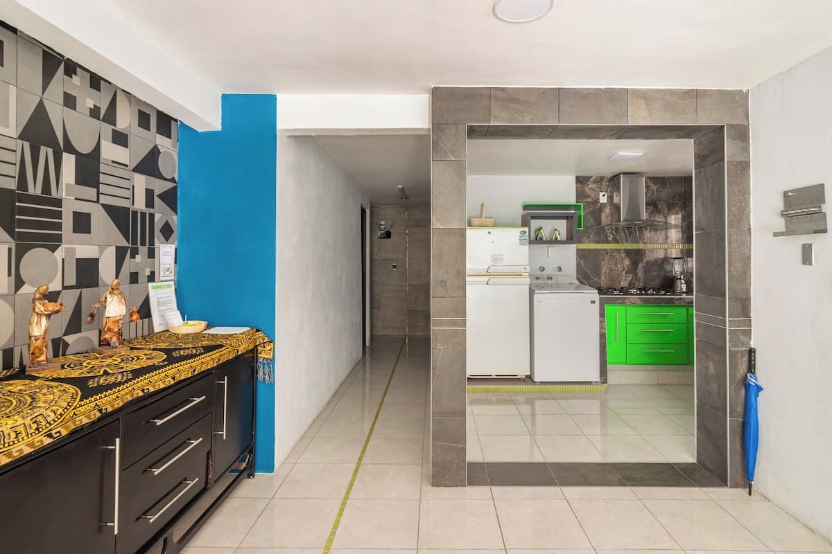 Une cuisine moderne équipée d’une cuisinière intégrée, d’un four à micro-ondes et d’un meuble vert.