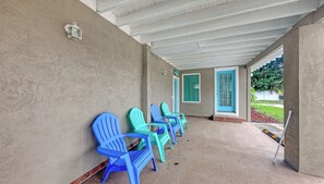 A covered outdoor seating area with blue chairs and a white ceiling. - Pool, Spacious House, Close to Siesta and Downtown (Sarasota)