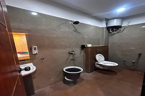 A modern bathroom with a toilet, bidet, and a shower. - FabHotel Aarav 94 (Indore)