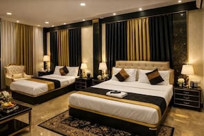 A hotel room with two beds, a large sitting area, and a decorative rug. - FabHotel Aarav 94 (Indore)
