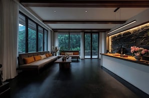 A modern interior with a sofa, a coffee table, and a stone accent wall.