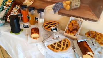 A dessert display with various baked goods and beverages.