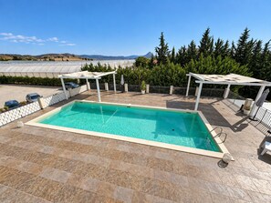 A rectangular swimming pool with a clear blue water surface, surrounded by a tiled deck. - Apartment in Mazzarino with 1 bedrooms sleeps 2 (Mazzarino)