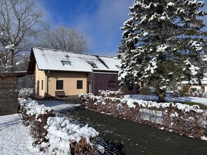 A house with a sloped roof, a brick section, and a number '13' on the door. - Vrbo Property (Lenz)