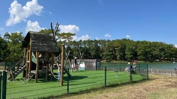 A playground with a climbing structure and a fenced area.