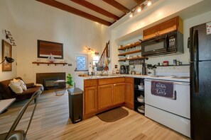 A modern kitchen with wooden cabinets, a built-in microwave, and a stainless steel refrigerator. - Private Casita - Hot Tub, Loft, Near Boat Ramp 23 (Canyon Lake)