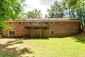 A two-story brick building with a covered patio area and a small balcony. - Atlanta Home w/ Deck, 18 Mi Outside Dtwn (Atlanta)