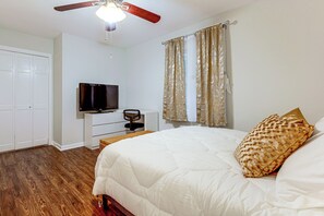 A bedroom with a bed, a television, a ceiling fan, and a wardrobe. - Atlanta Home w/ Deck, 18 Mi Outside Dtwn (Atlanta)