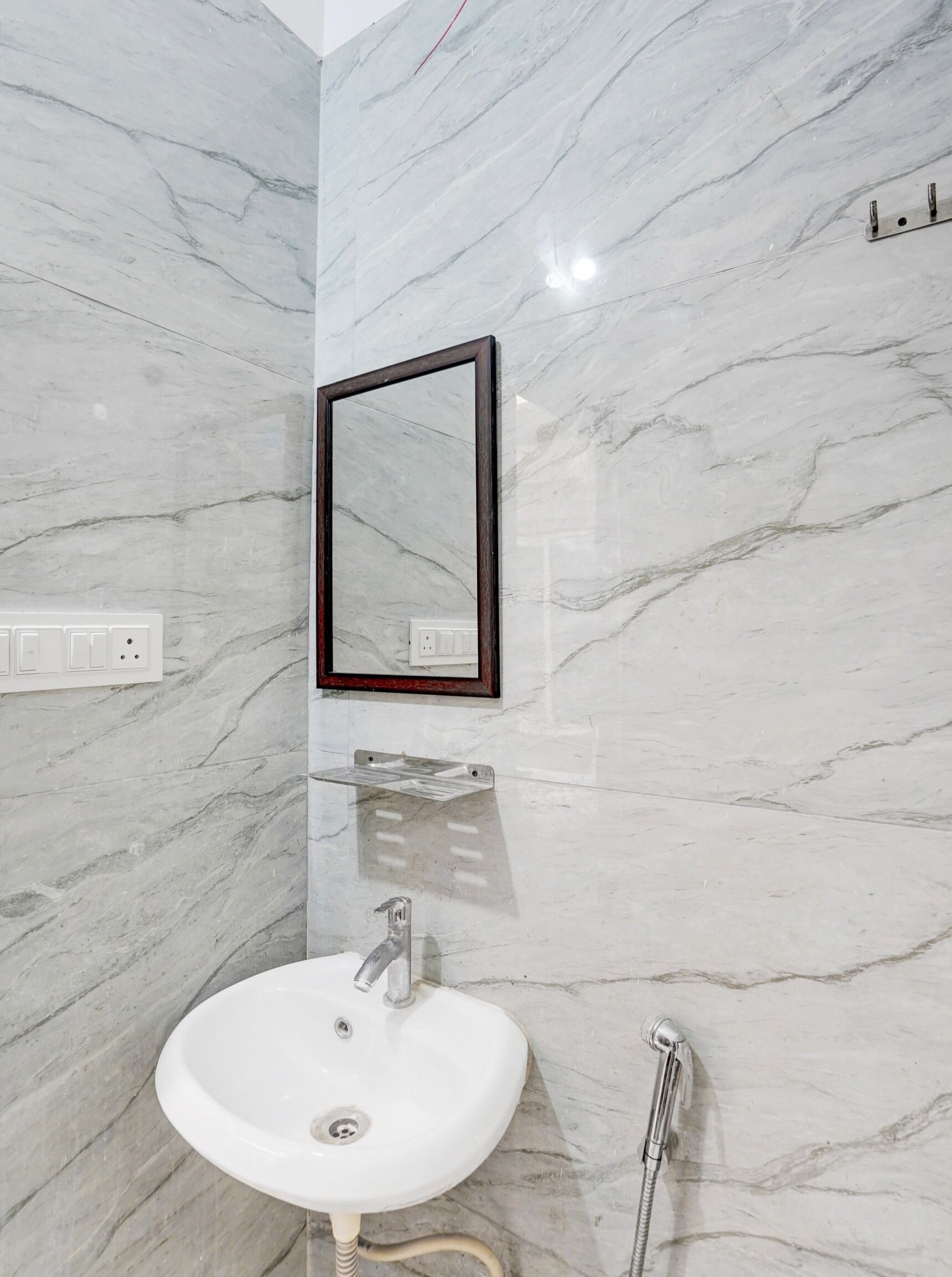A bathroom with a white sink, a mirror, and a shower.