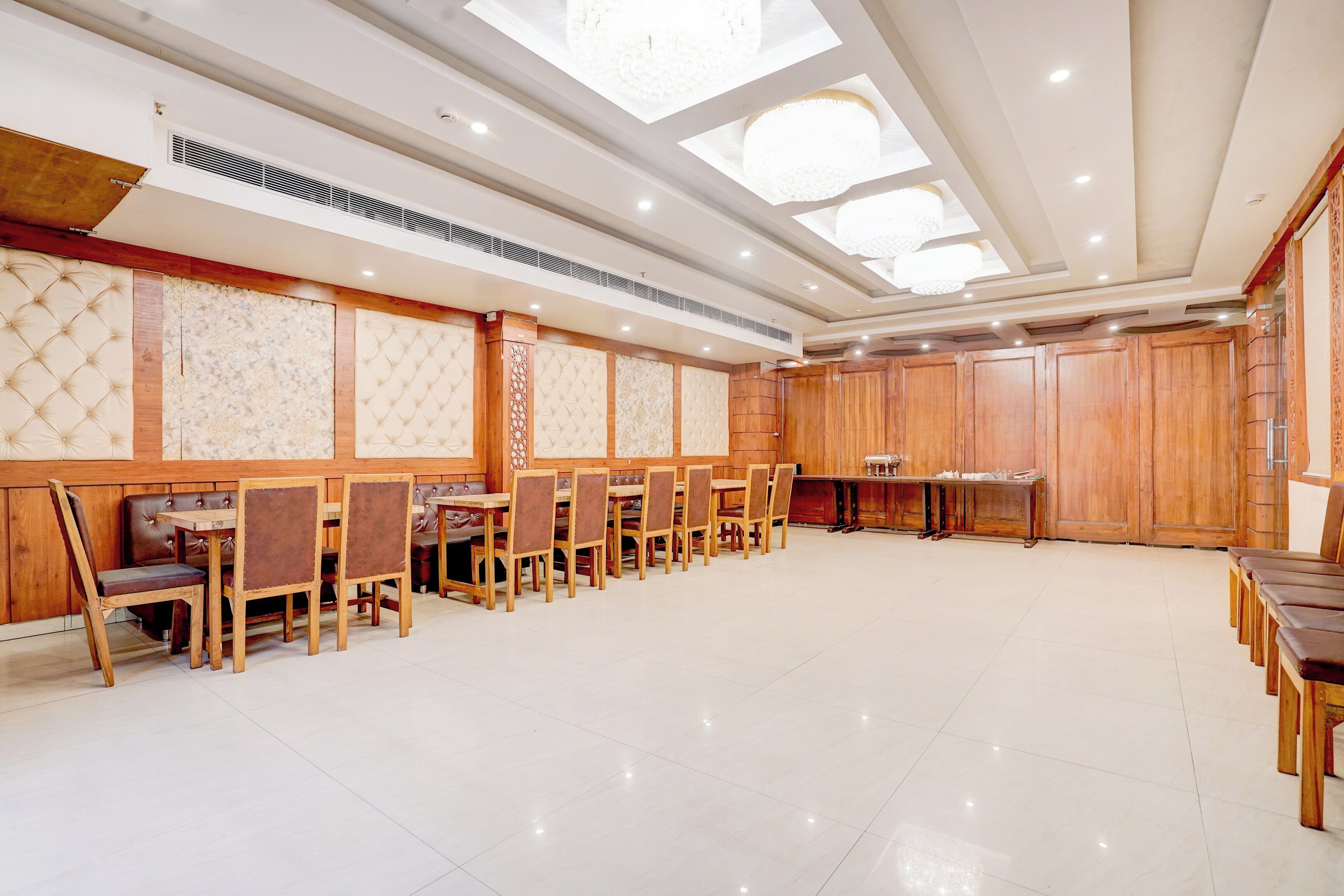 A spacious room with a high ceiling, recessed lighting, and a skylight.